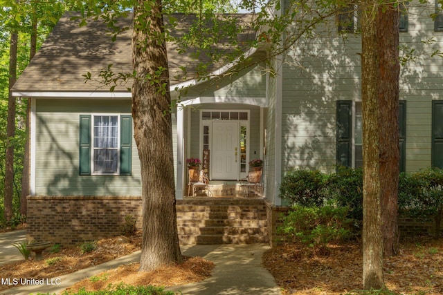 property entrance featuring brick siding