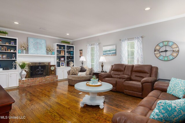 living room featuring ornamental molding, a brick fireplace, wood finished floors, and recessed lighting