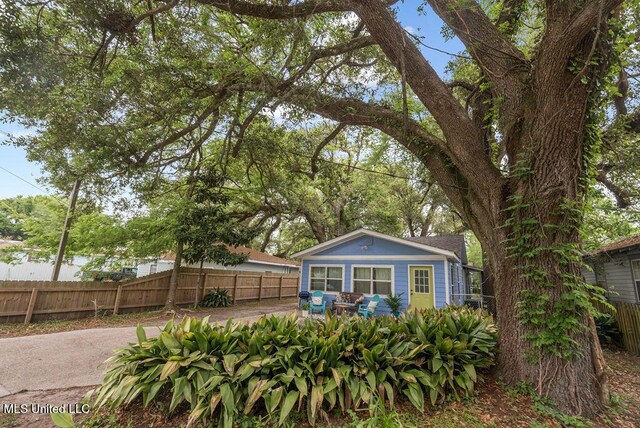 317 Ballentine St, Bay Saint Louis, MS 39520 - rear view of house featuring fence and a patio