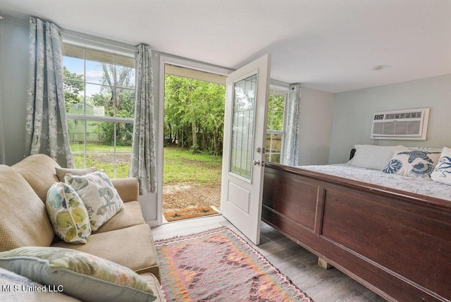317 Ballentine St, Bay Saint Louis, MS 39520 - bedroom with french doors, wood finished floors, an AC wall unit, and access to exterior