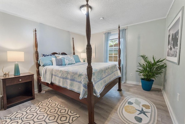 317 Ballentine St, Bay Saint Louis, MS 39520 - bedroom with light wood finished floors, baseboards, and a textured ceiling
