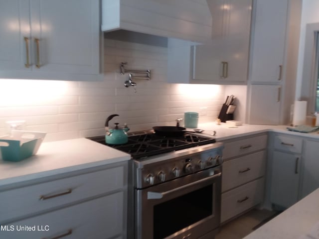 683B Cedar Hill Rd, Flora, MS 39071 - kitchen with gas stove, backsplash, and light countertops