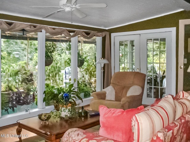 sunroom / solarium with ceiling fan and french doors