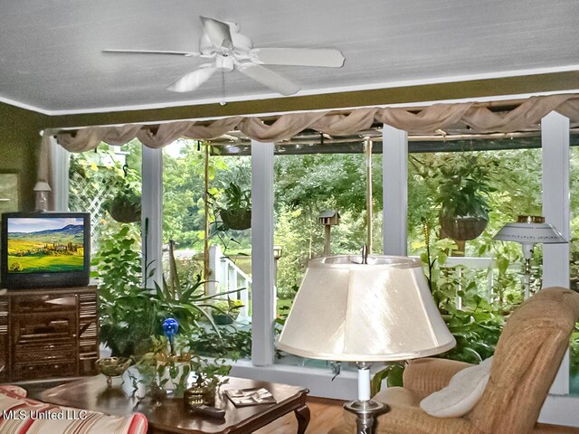 sunroom featuring ceiling fan