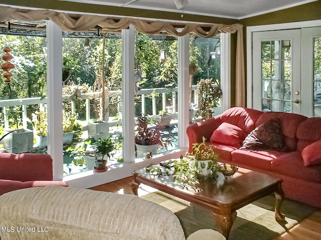 sunroom featuring french doors and a healthy amount of sunlight