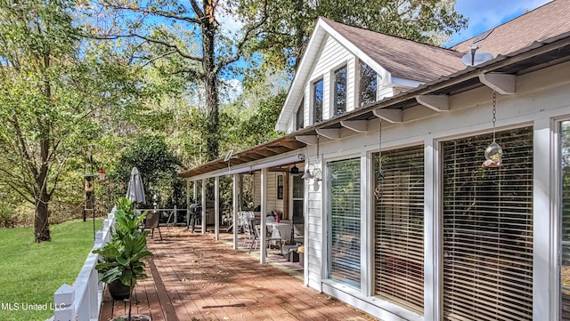 exterior space featuring a lawn and a deck