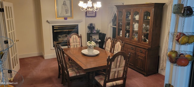 carpeted dining space featuring a notable chandelier