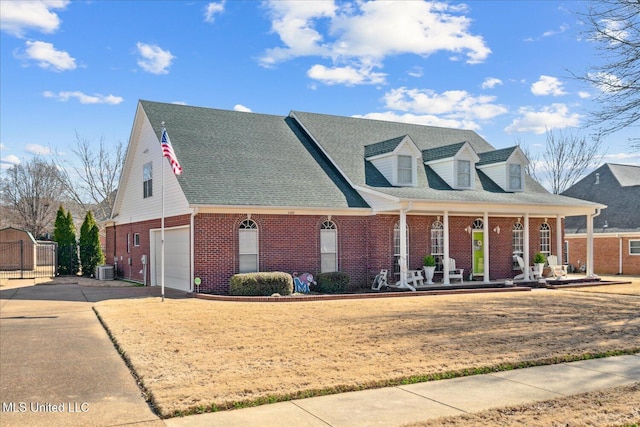 cape cod home featuring concrete driveway, covered porch, brick siding, and a shingled roof