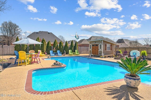 view of swimming pool featuring a fire pit, a fenced in pool, and a fenced backyard