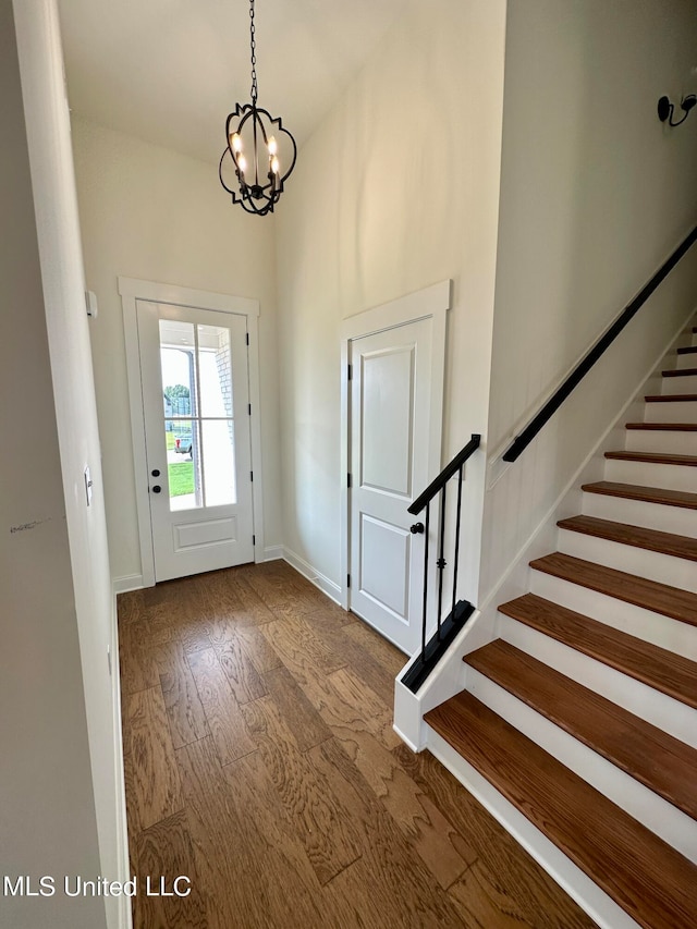 entryway with a notable chandelier and hardwood / wood-style flooring