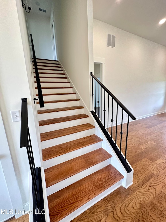 stairway with hardwood / wood-style floors