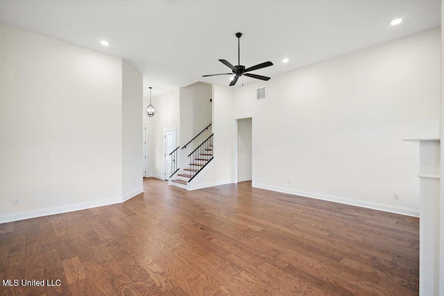 unfurnished living room featuring dark hardwood / wood-style floors and ceiling fan