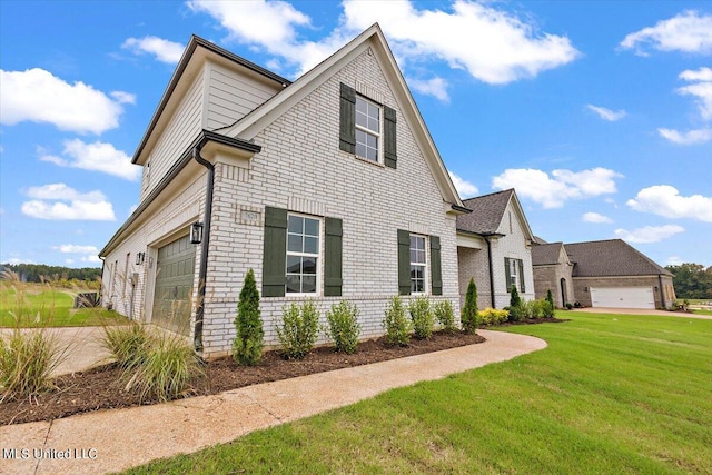 view of front of property with a front yard and a garage