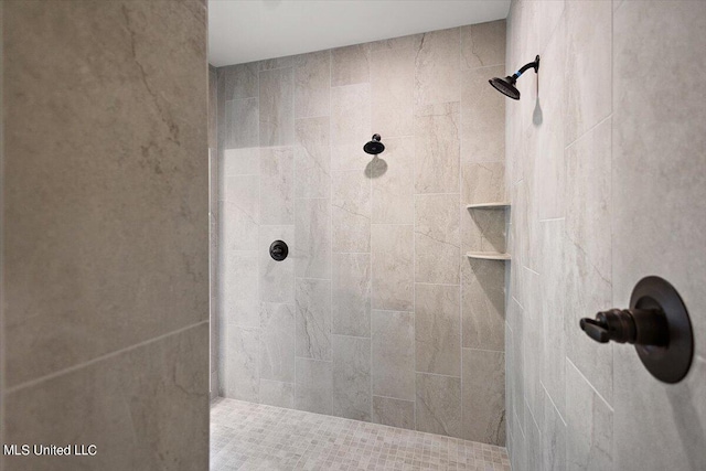 bathroom with tiled shower