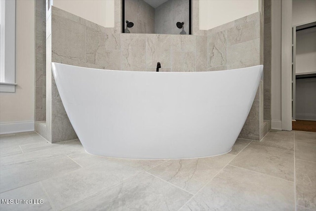 bathroom with tile walls, plus walk in shower, and tile patterned flooring