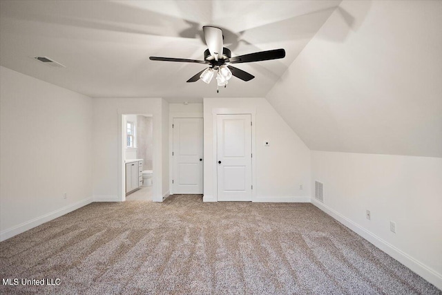 bonus room with vaulted ceiling, light colored carpet, and ceiling fan