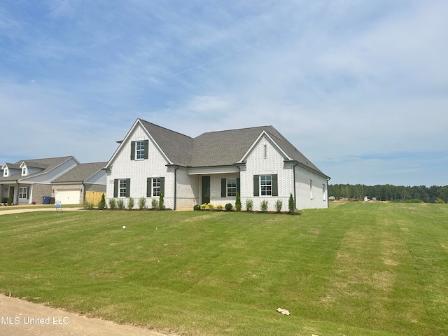 view of front of property with a front lawn and a garage