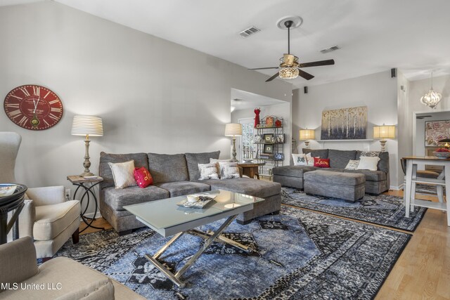 living area featuring wood finished floors, a ceiling fan, and visible vents