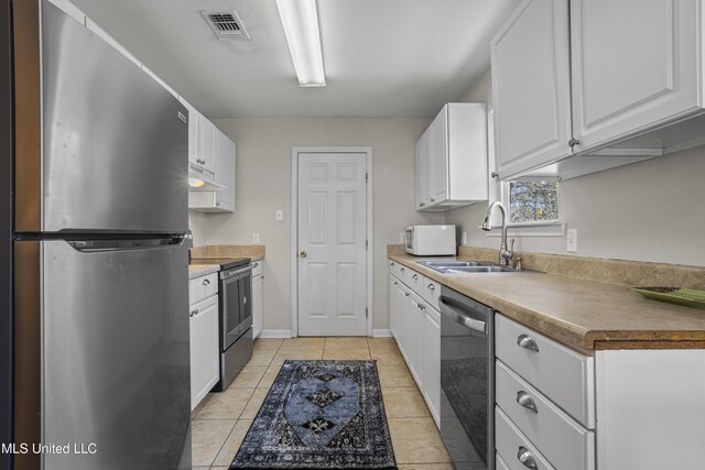 kitchen with visible vents, a sink, white cabinets, under cabinet range hood, and appliances with stainless steel finishes