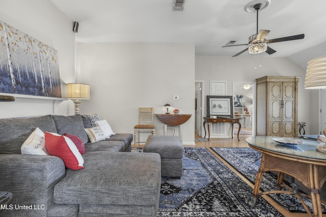 living area featuring visible vents, wood finished floors, lofted ceiling, and ceiling fan