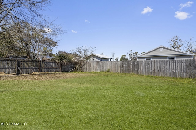 view of yard with a fenced backyard