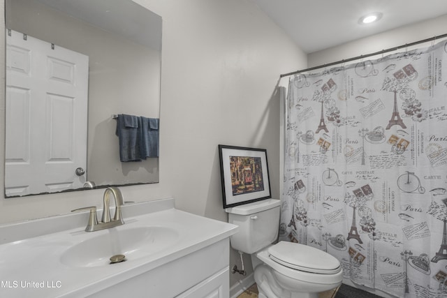 bathroom with toilet and vanity