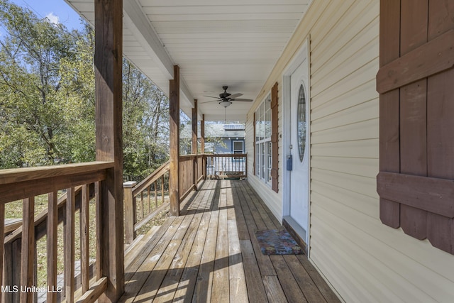 wooden terrace with a porch and a ceiling fan