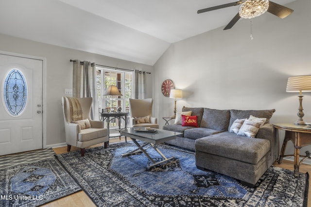 living room with baseboards, lofted ceiling, ceiling fan, and wood finished floors