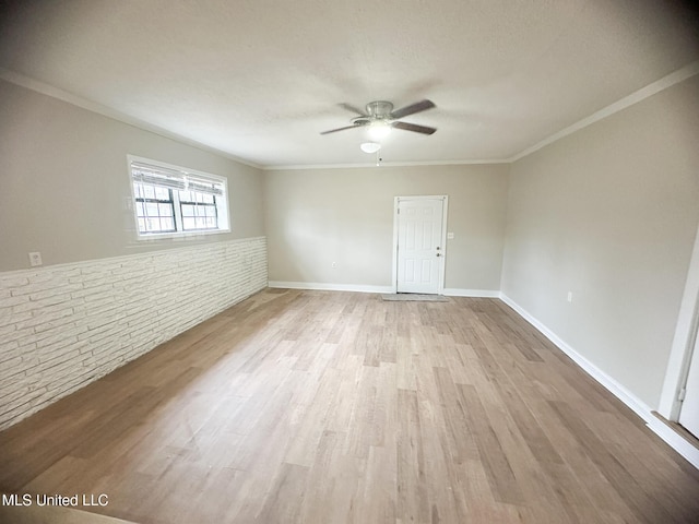 unfurnished room featuring ornamental molding, ceiling fan, and light wood-type flooring