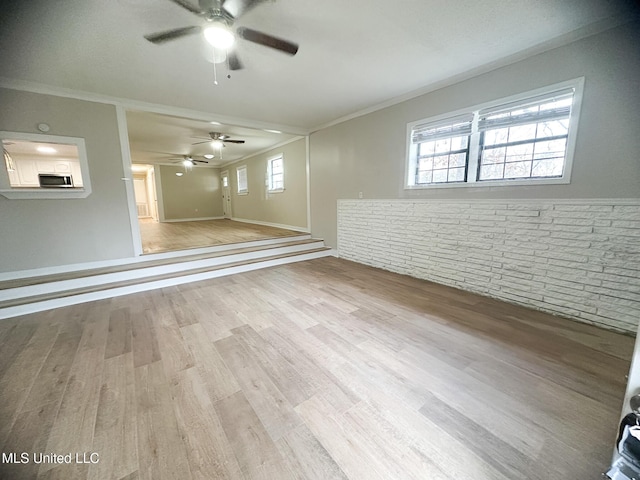 basement with crown molding and light hardwood / wood-style floors