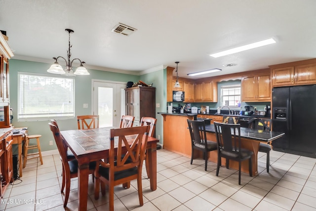 5421 Espy Ave, Long Beach, MS 39560 - dining area with ornamental molding, light tile patterned floors, and a chandelier