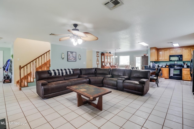 5421 Espy Ave, Long Beach, MS 39560 - living room with a ceiling fan, light tile patterned floors, and stairs