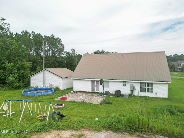 5421 Espy Ave, Long Beach, MS 39560 - back of house with a fire pit, a patio, a lawn, and a metal roof