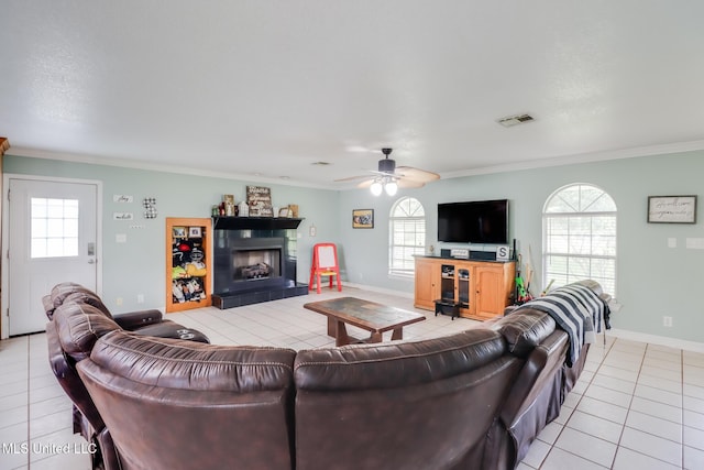5421 Espy Ave, Long Beach, MS 39560 - living area featuring light tile patterned floors, ceiling fan, healthy amount of natural light, a fireplace, and ornamental molding