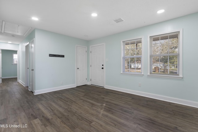 entrance foyer featuring dark wood-type flooring, visible vents, and baseboards