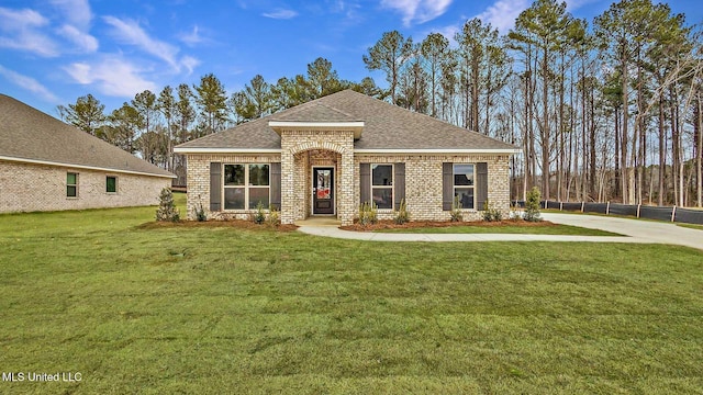710 Honeysuckle Loop, Canton, MS 39046 - view of front of house featuring a shingled roof and brick siding