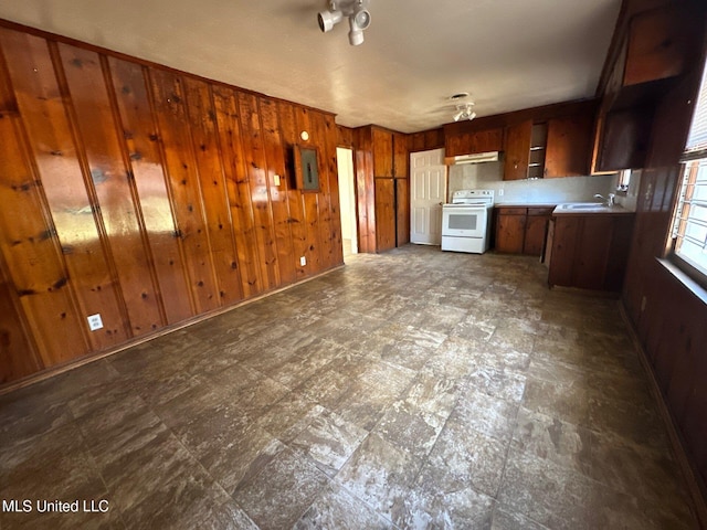 kitchen featuring sink, electric panel, wooden walls, and electric stove