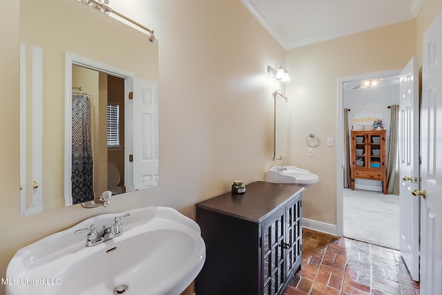 bathroom featuring a shower with curtain, sink, and crown molding