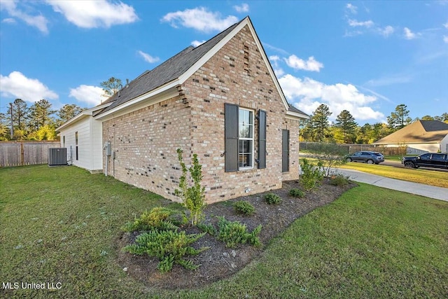 view of side of property with cooling unit and a yard