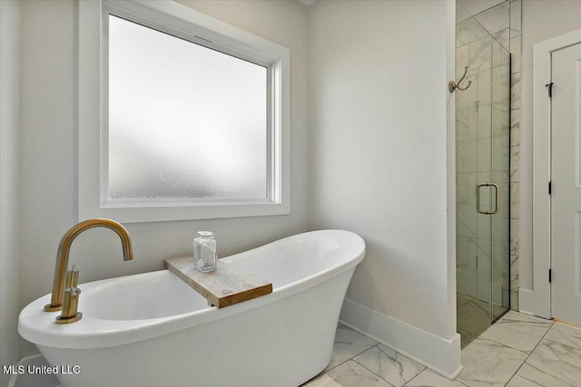 bathroom featuring separate shower and tub