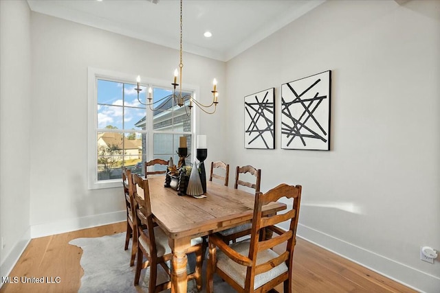 dining space featuring a chandelier and light hardwood / wood-style flooring