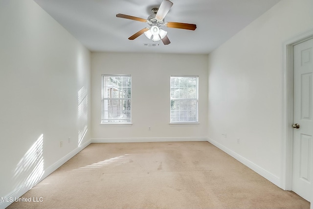 unfurnished room featuring ceiling fan and light colored carpet