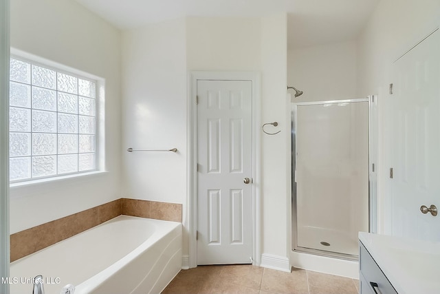 bathroom featuring tile patterned floors, vanity, and independent shower and bath