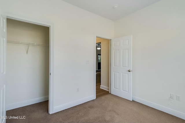 unfurnished bedroom featuring a closet and carpet flooring