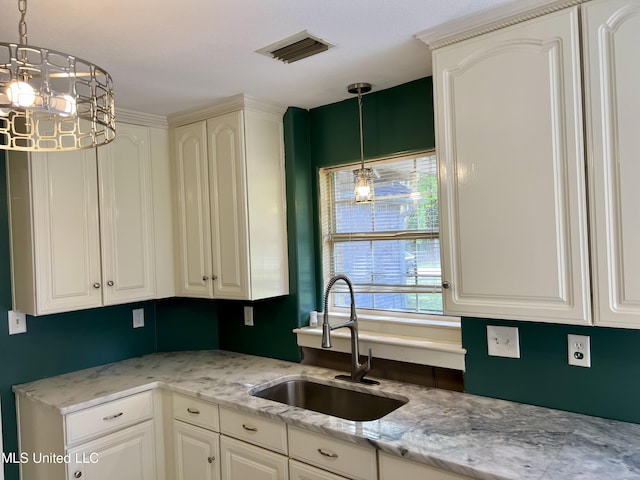 8004 Martin Bluff Rd, Gautier, MS 39553 - kitchen with pendant lighting, light stone countertops, and a chandelier