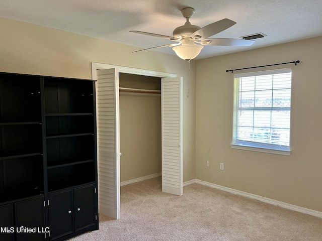 8004 Martin Bluff Rd, Gautier, MS 39553 - unfurnished bedroom with a closet, light carpet, and ceiling fan