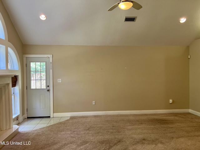 8004 Martin Bluff Rd, Gautier, MS 39553 - entrance foyer featuring light colored carpet, a ceiling fan, vaulted ceiling, light tile patterned floors, and a fireplace