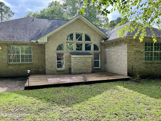 8004 Martin Bluff Rd, Gautier, MS 39553 - rear view of house with a yard, brick siding, a shingled roof, and a deck