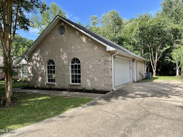 8004 Martin Bluff Rd, Gautier, MS 39553 - view of property exterior with brick siding, a garage, driveway, and a lawn