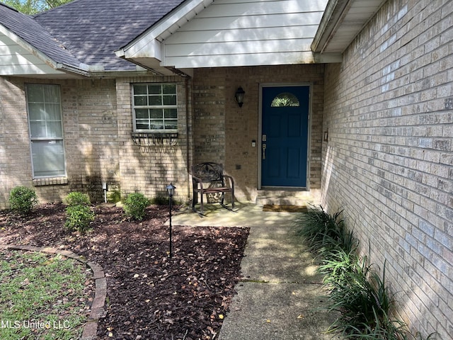 8004 Martin Bluff Rd, Gautier, MS 39553 - doorway to property featuring brick siding and roof with shingles